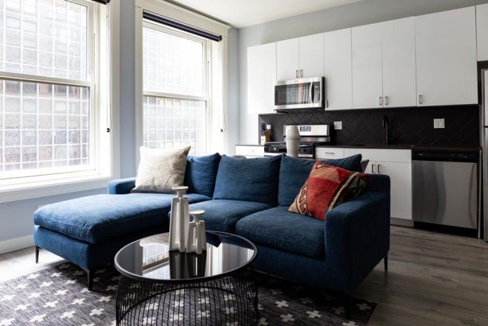 bankmodel met een blauwe ottoman in het interieur