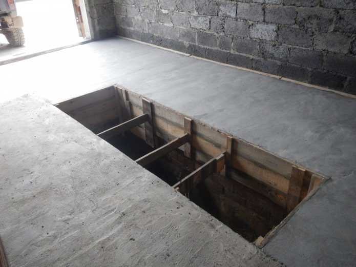 betonvloer in een garage met een put